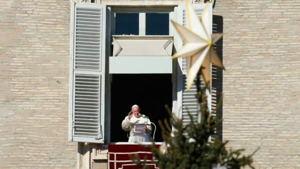 The Christmas tree is seen as Pope Francis leads the Angelus from the window of his studio overlooking St. Peter's Square at the Vatican Dec. 19, 2021. (CNS photo/Paul Haring)