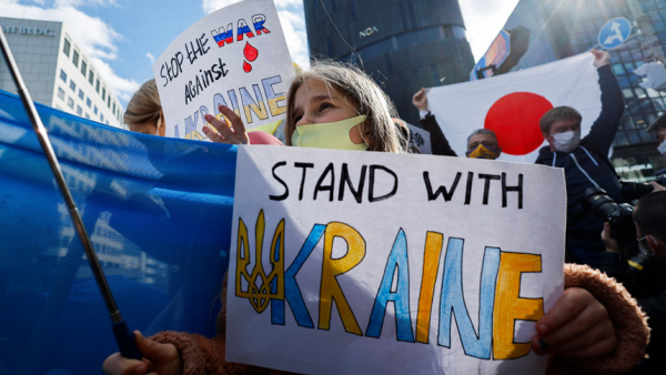 A Ukrainian residing in Japan shows a placard during a protest rally denouncing Russia over its actions in Ukraine, near the Russian Embassy in Tokyo Feb. 23, 2022. Pope Francis expressed "great sorrow" over the situation in Ukraine and called on Christians to observe a day of prayer and fasting for peace on Ash Wednesday, March 2. (CNS photo/Issei Kato, Reuters)