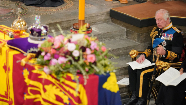 King Charles III sits in front of the coffin of his mother, Queen Elizabeth II, during her state funeral at Westminster Abbey in London Sept. 19, 2022. (CNS photo/Dominic Lipinski, pool via Reuters)